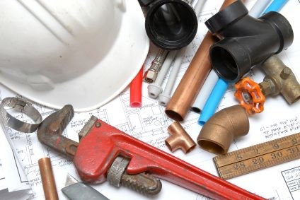 Plumbing parts, tools, and plans used by Palmerio Plumbing LLC.